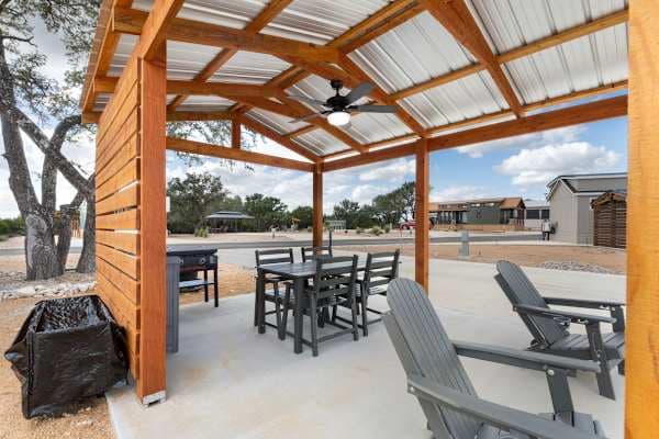 Shaded gazebo with privacy screen, griddle and Adirondack chairs